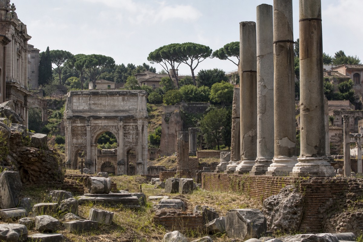The columns and arches of the Roman Forum at midday