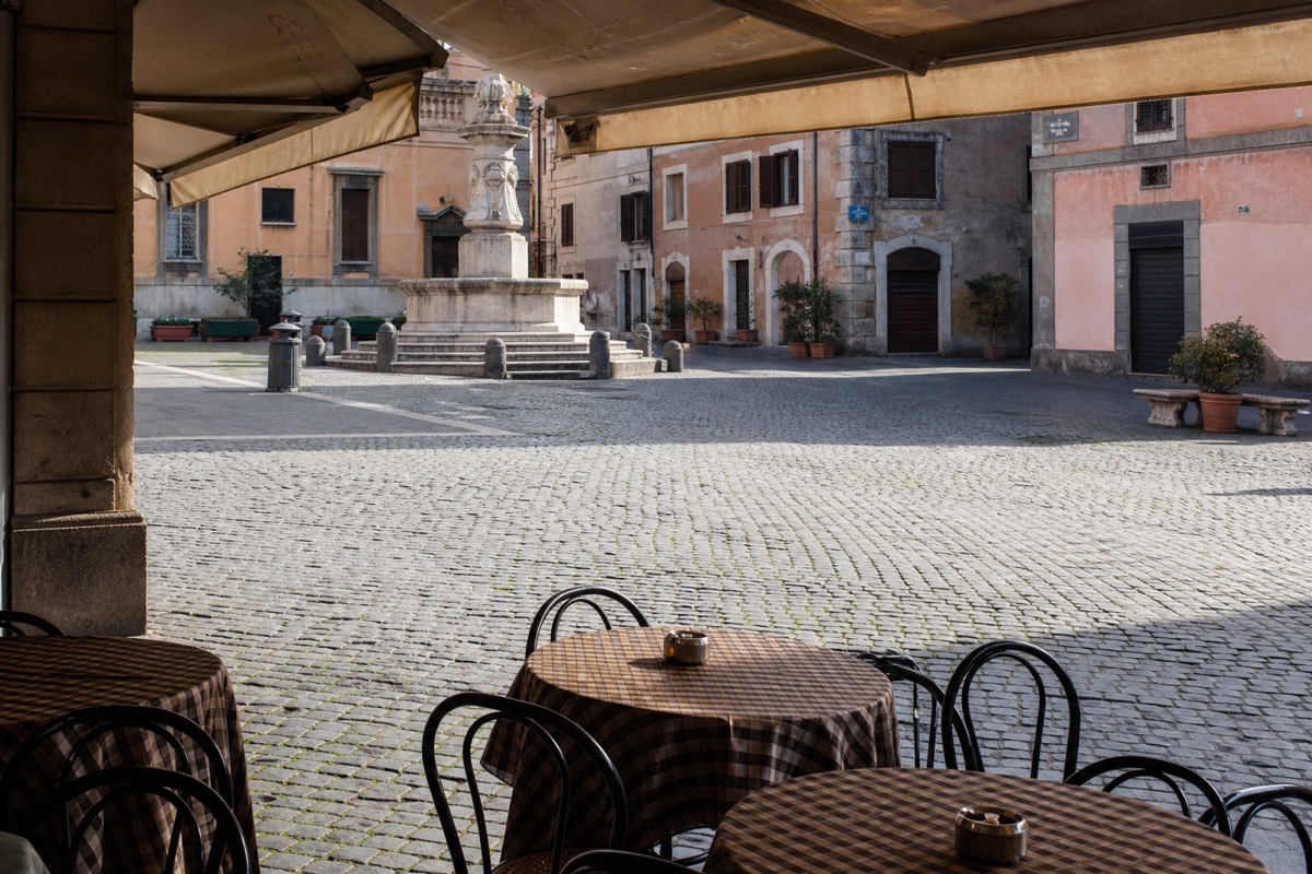 A cafe terrace on a Roman piazza in the afternoon