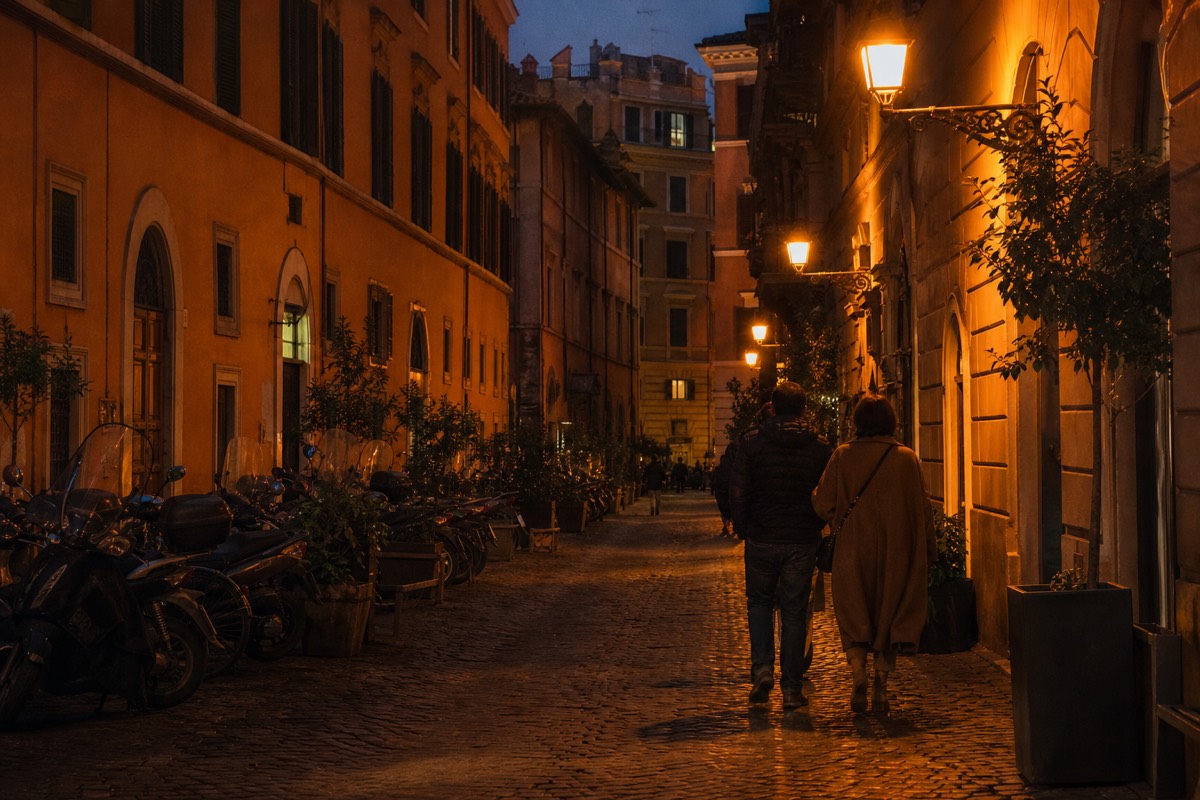A busy cobbled street in central Rome in the evening